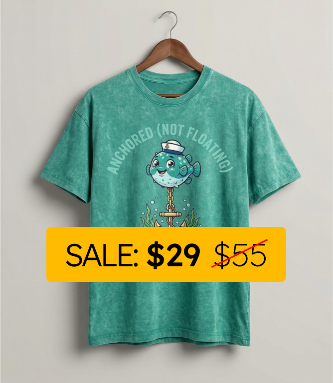 Green t-shirt with a cartoon fish design and sale label on a plain background