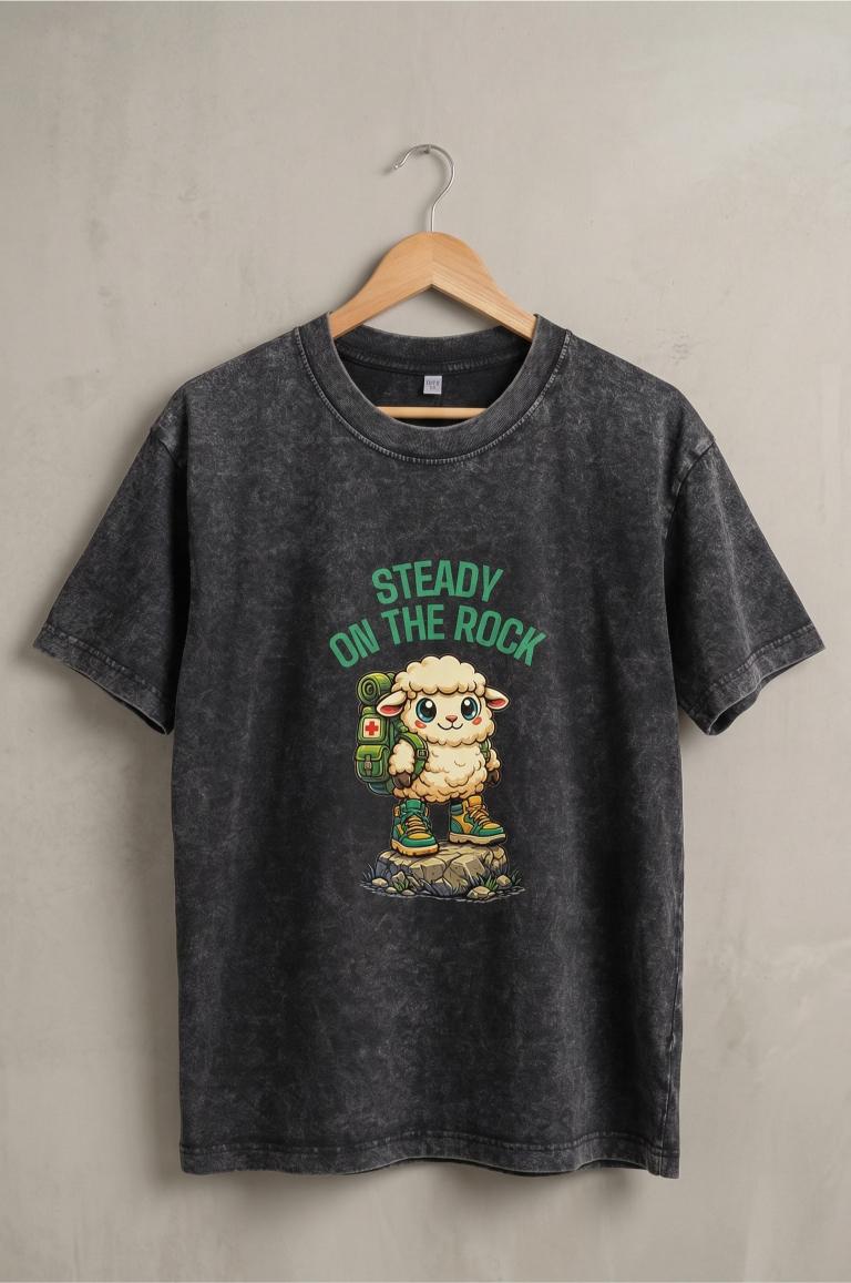 Black t-shirt with graphic design and text on a hanger against a gray background